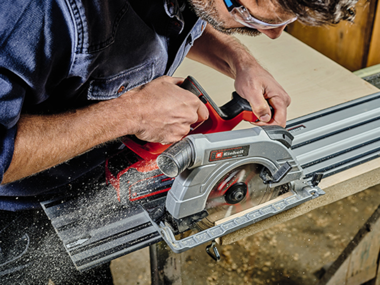 man cuts with a circular saw